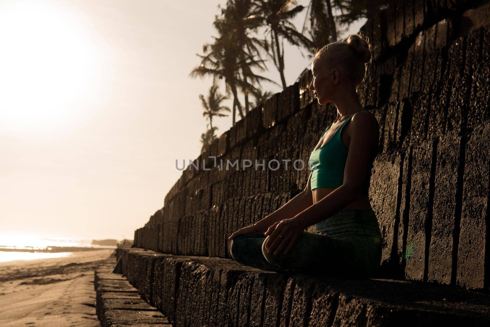 beautiful woman meditating outdoors by Alexzhilkin