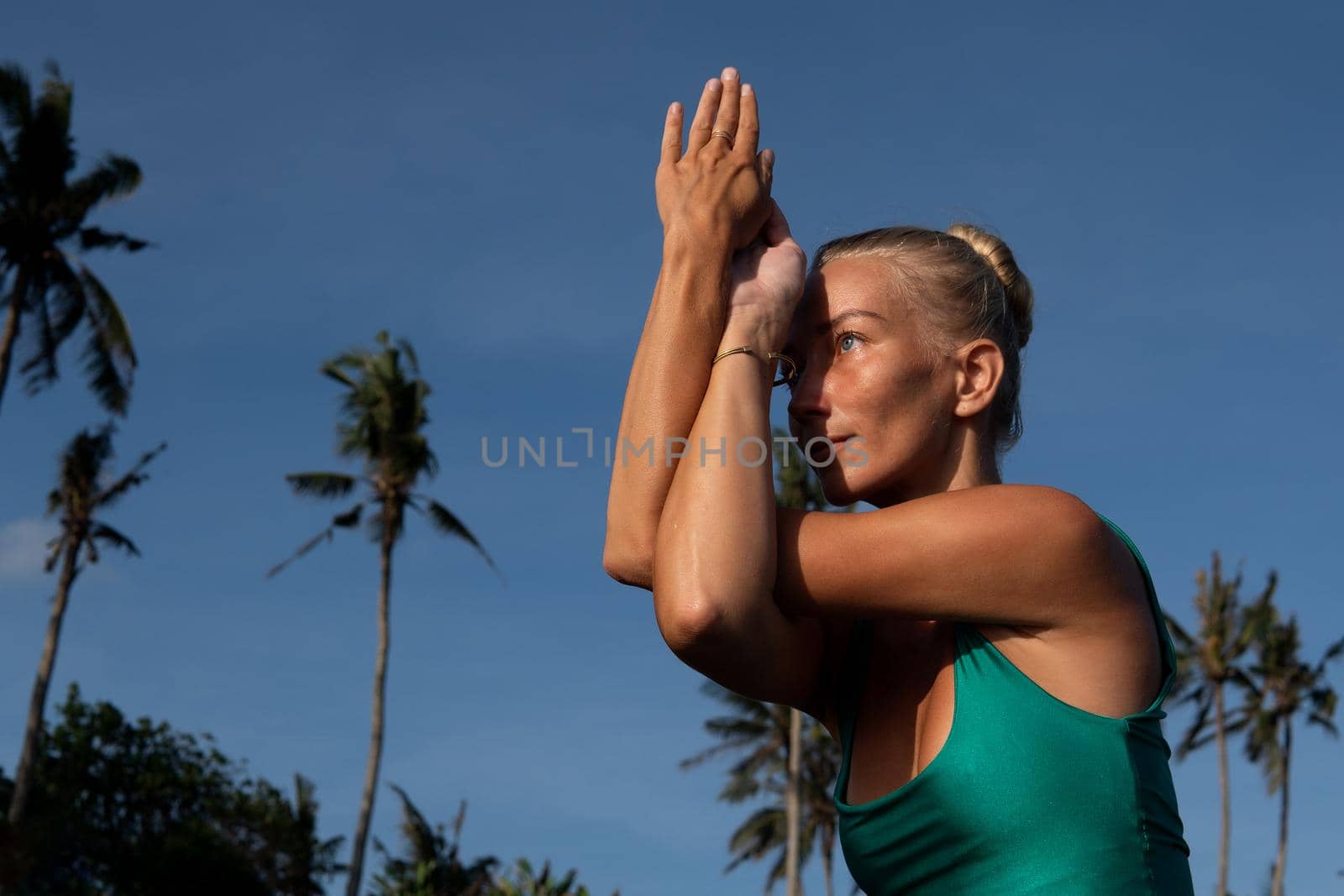 beautiful woman doing yoga on the beach by Alexzhilkin