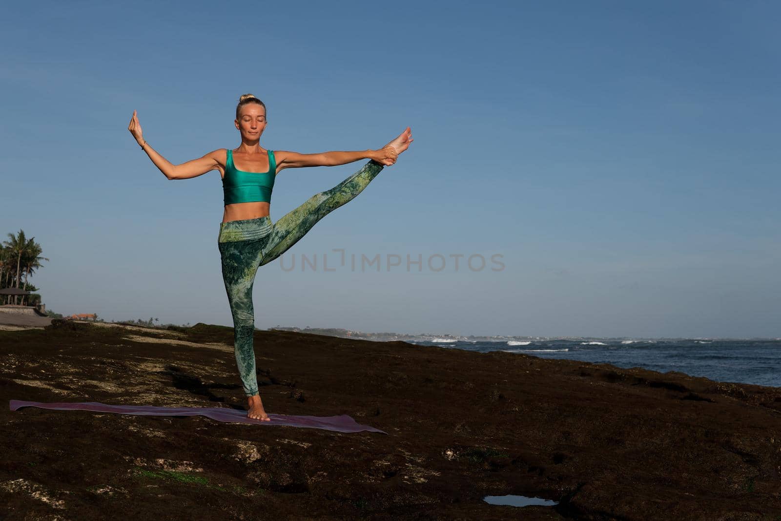 beautiful woman doing yoga. middle plan. bali