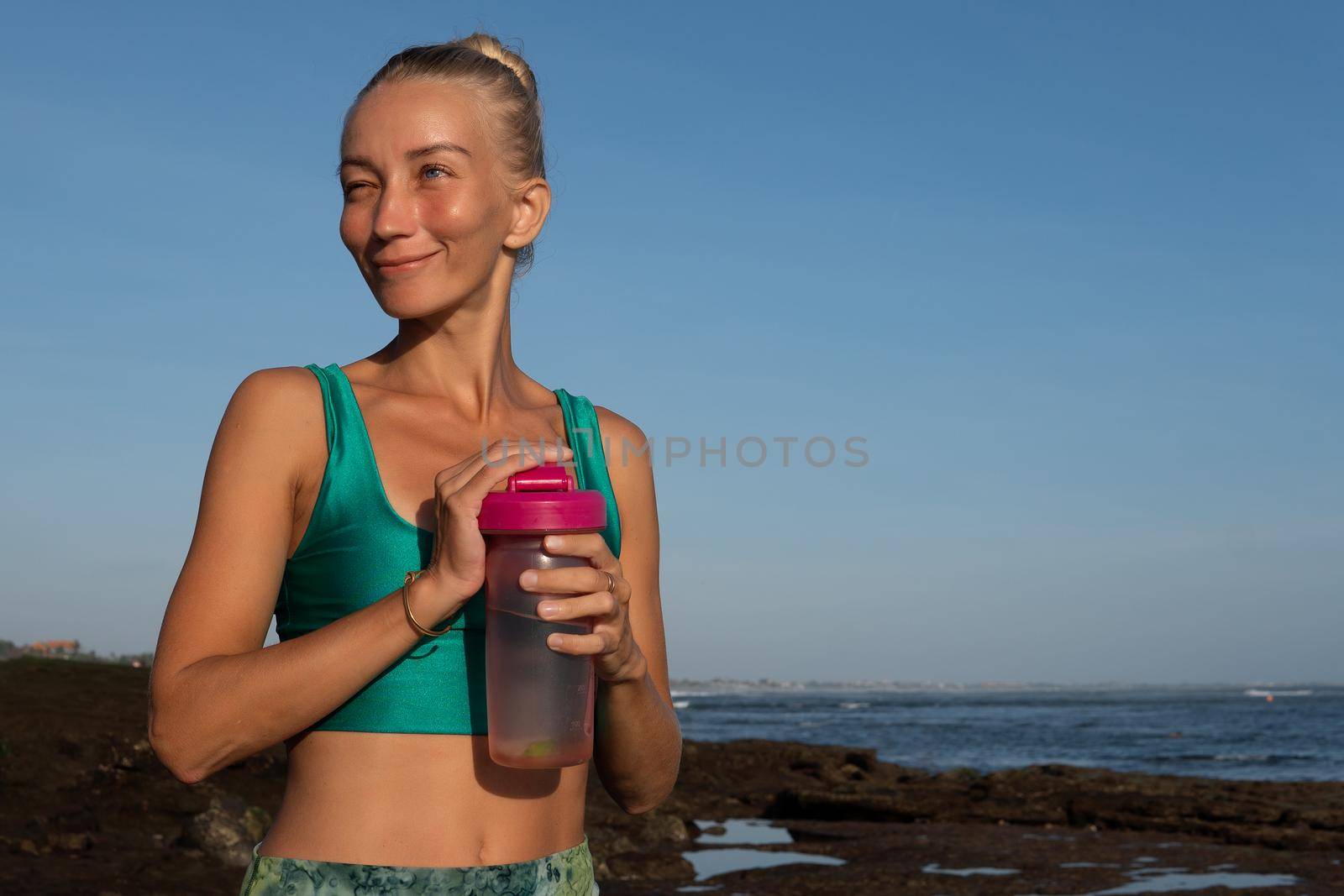 beautiful woman drinking water by Alexzhilkin