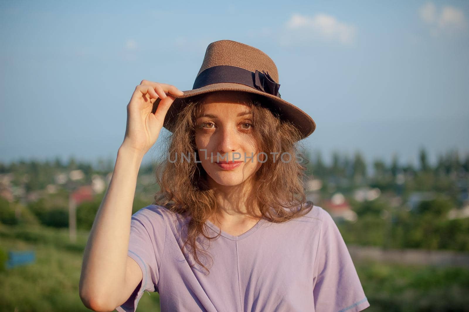 Young girl in dress is having great time during vacation in the summer on sky background in nature, travelling concept.