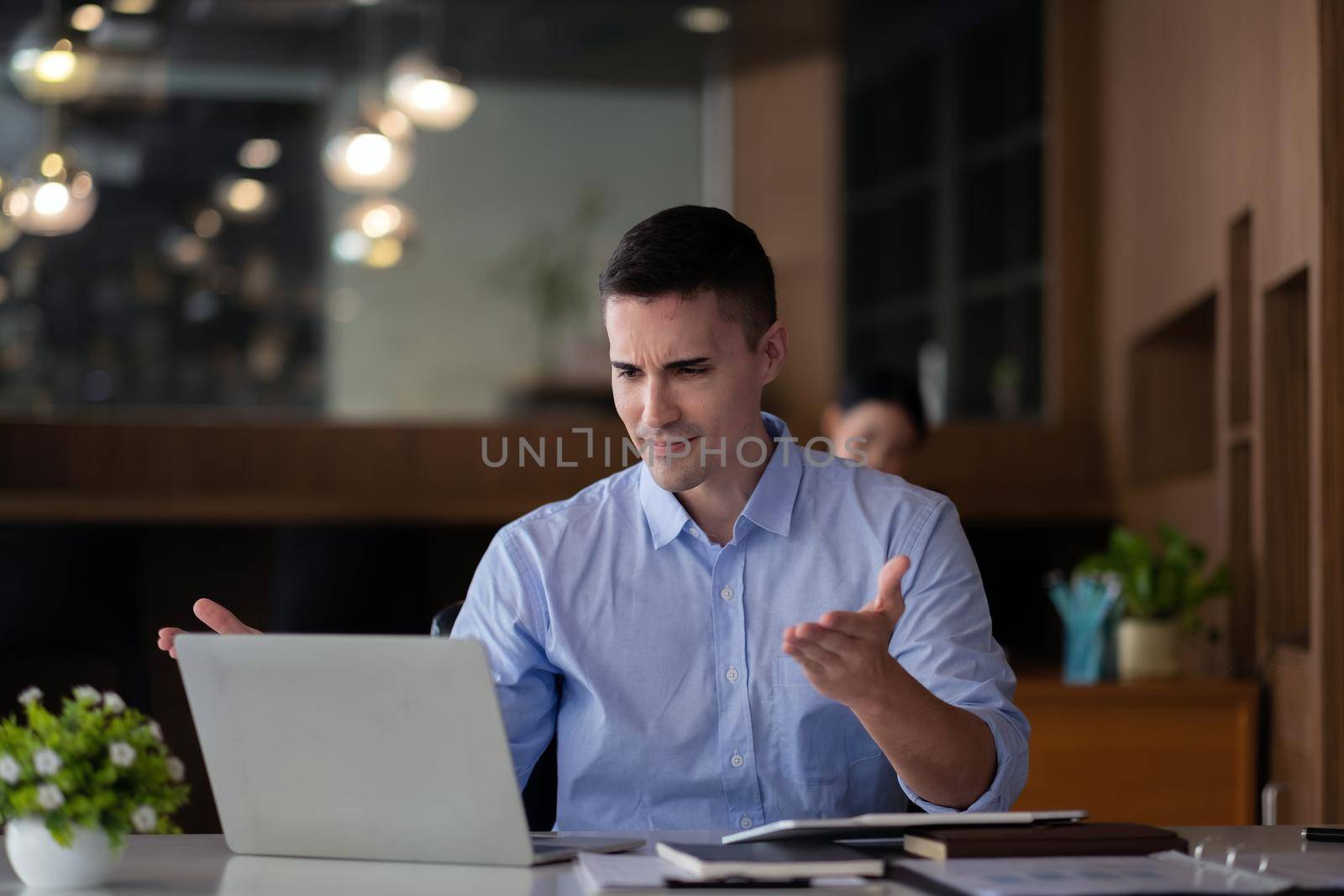 smiling businessman having virtual team meeting call, talking, remotely working at home watching online learning training webinar in remote office.