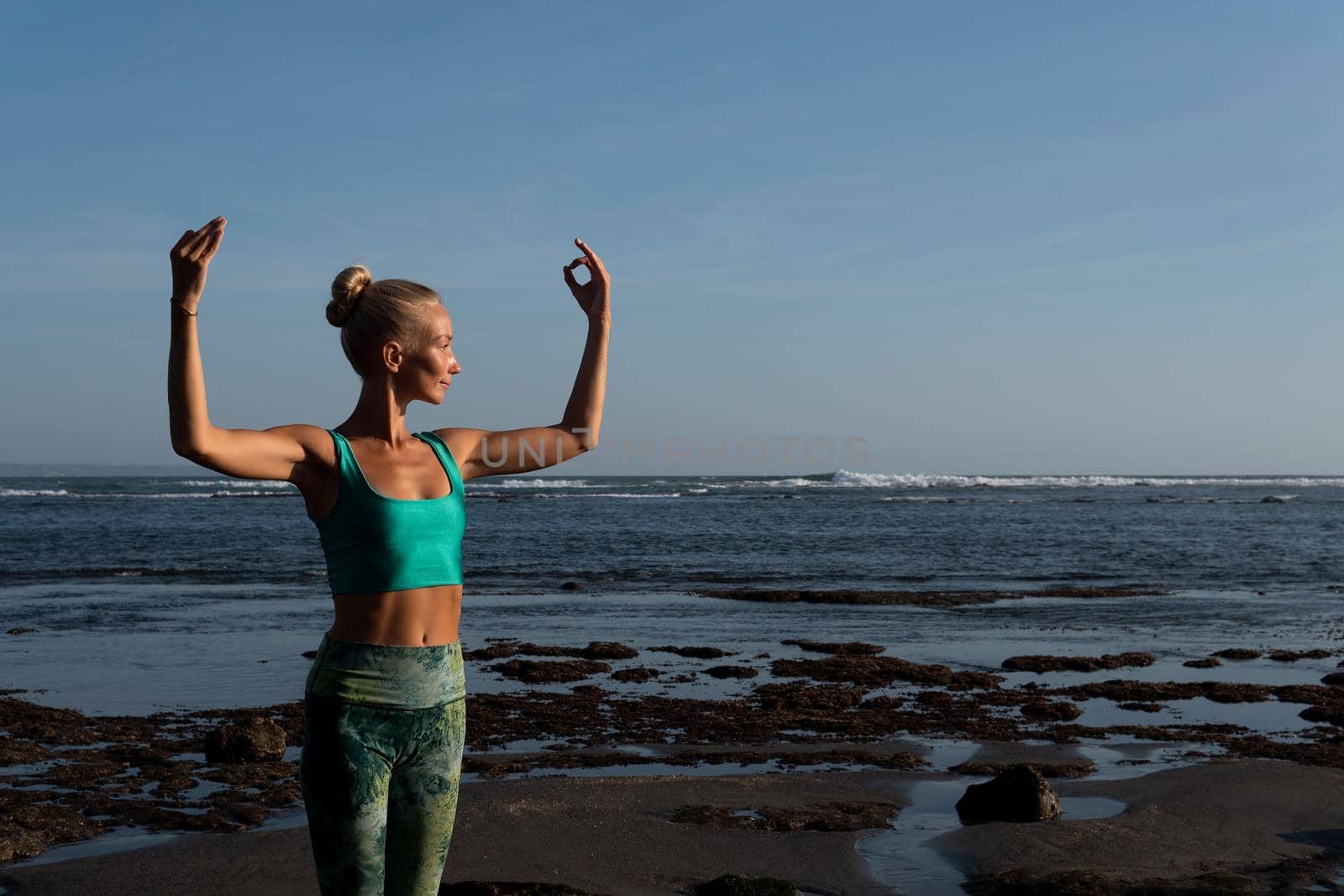 beautiful woman doing yoga on the beach. Bali