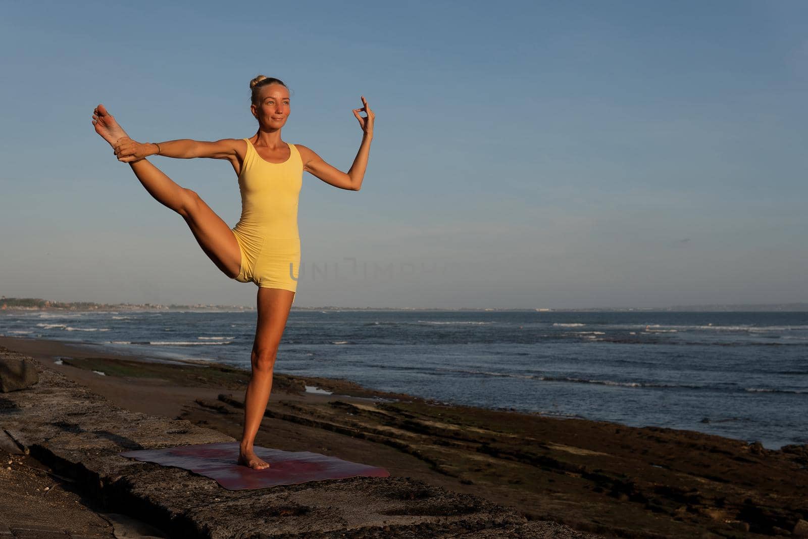 beautiful woman doing yoga on the beach. bali