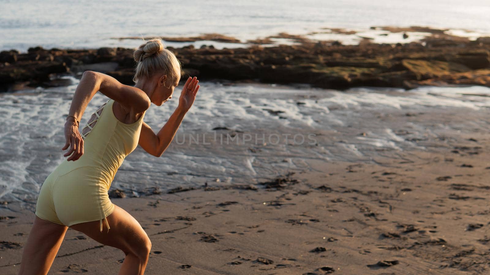 beautiful woman jogging on the beach by Alexzhilkin