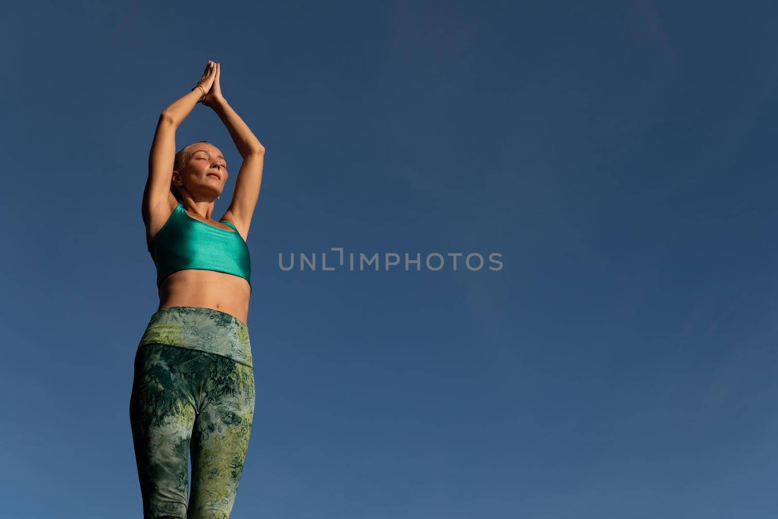 beautiful woman doing yoga. by Alexzhilkin