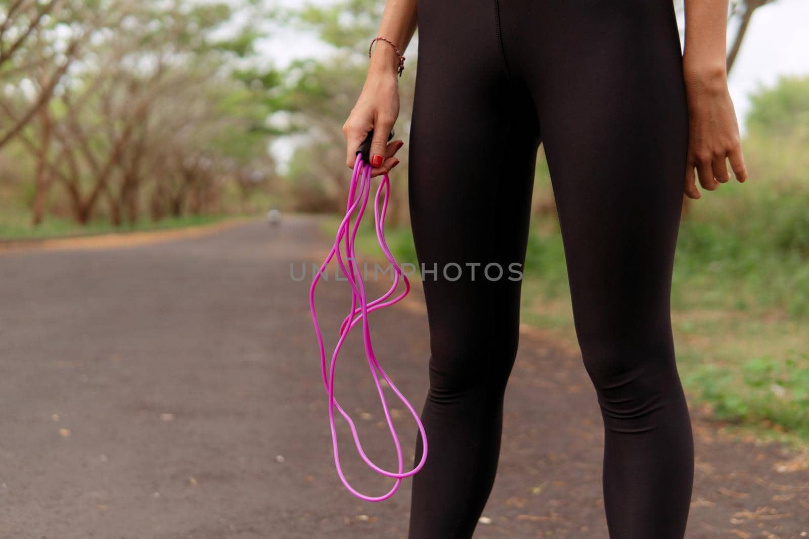 close up woman jumping pink rope. bali