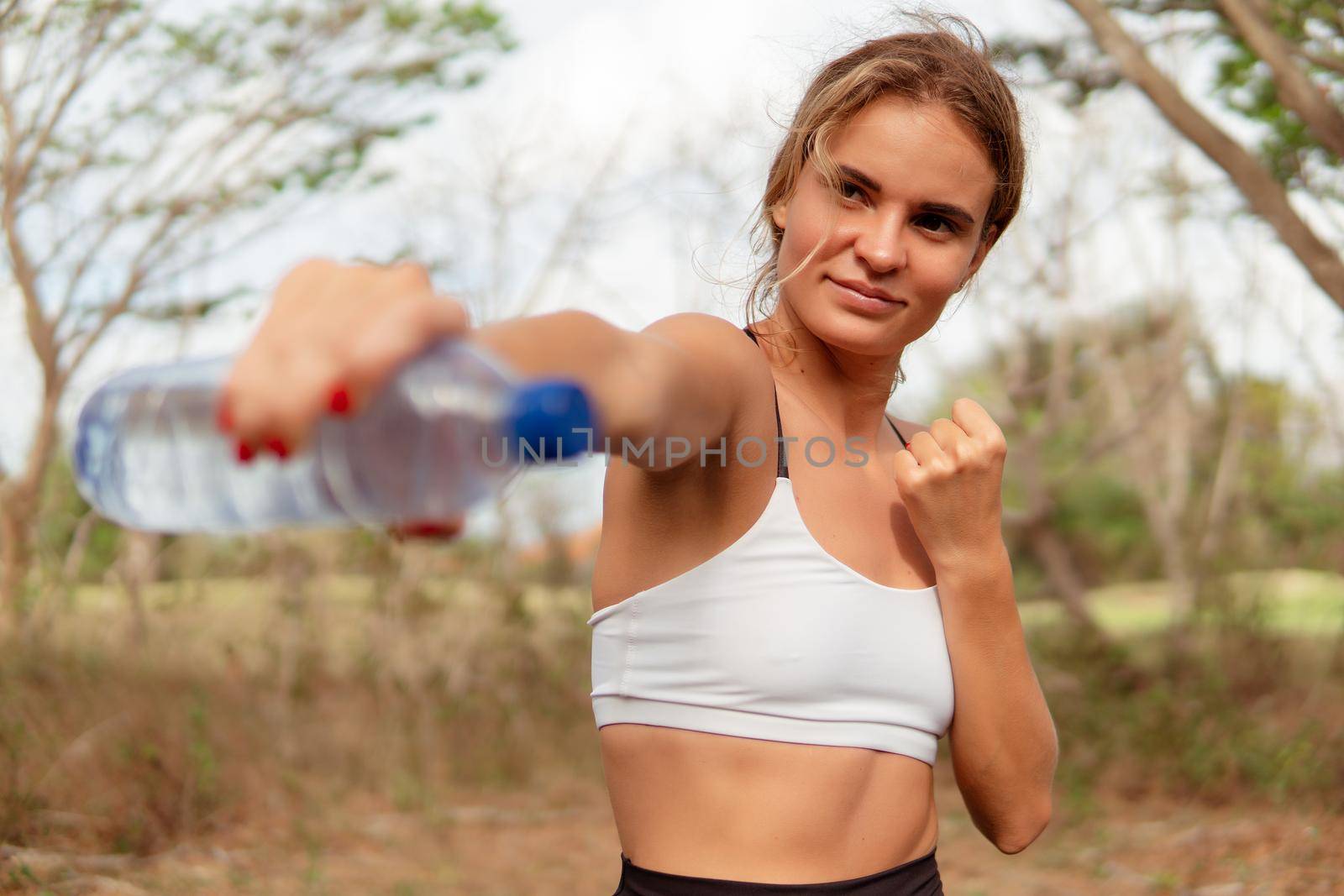 woman warm up with bottle of water. bali