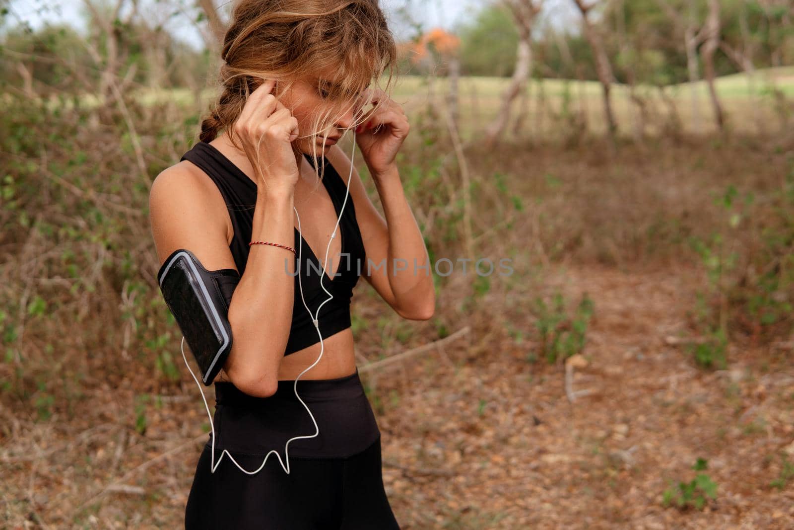 beautiful woman listening to music in the park