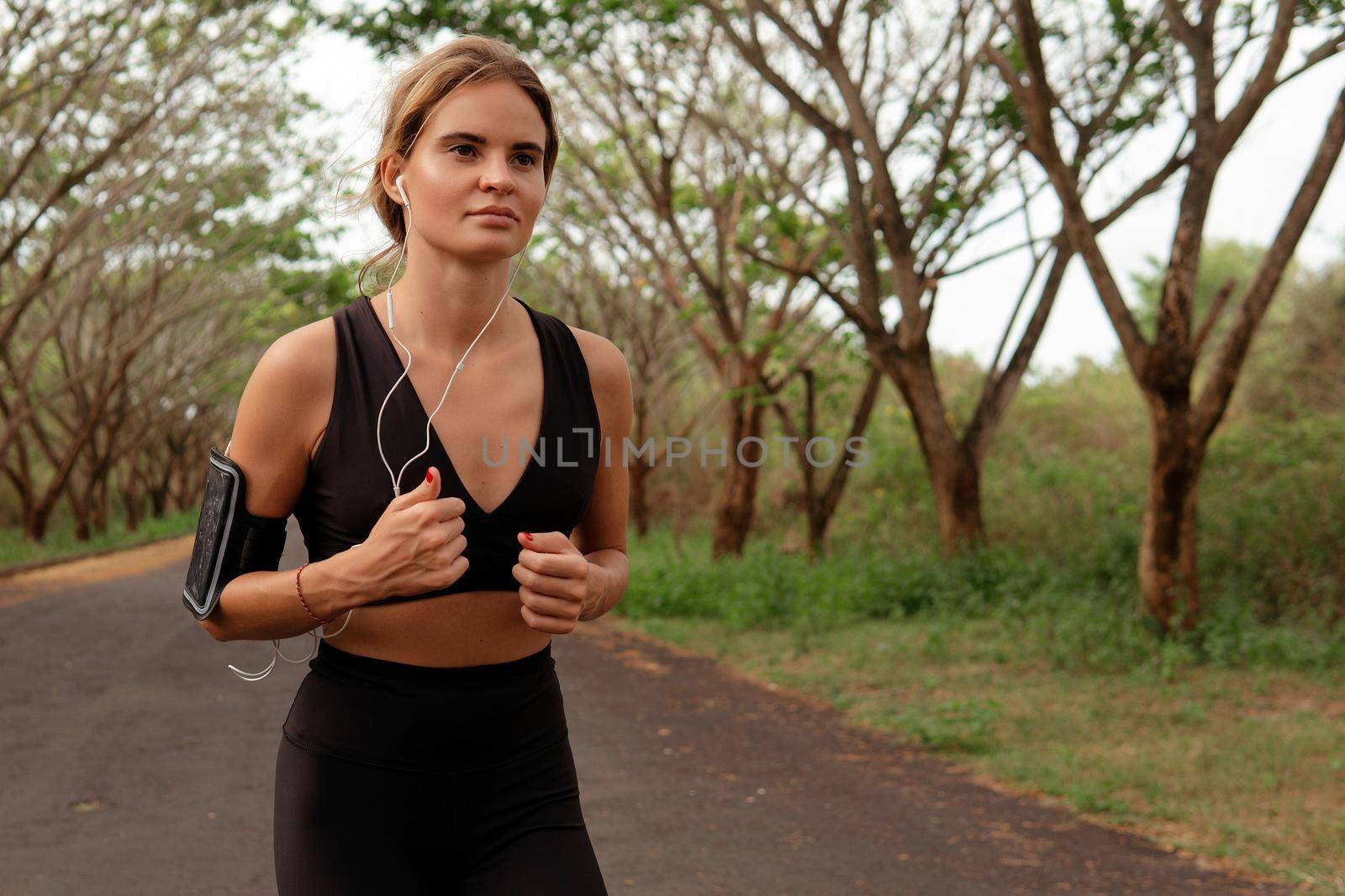 Beautiful girl go in for sports. autumn by Alexzhilkin