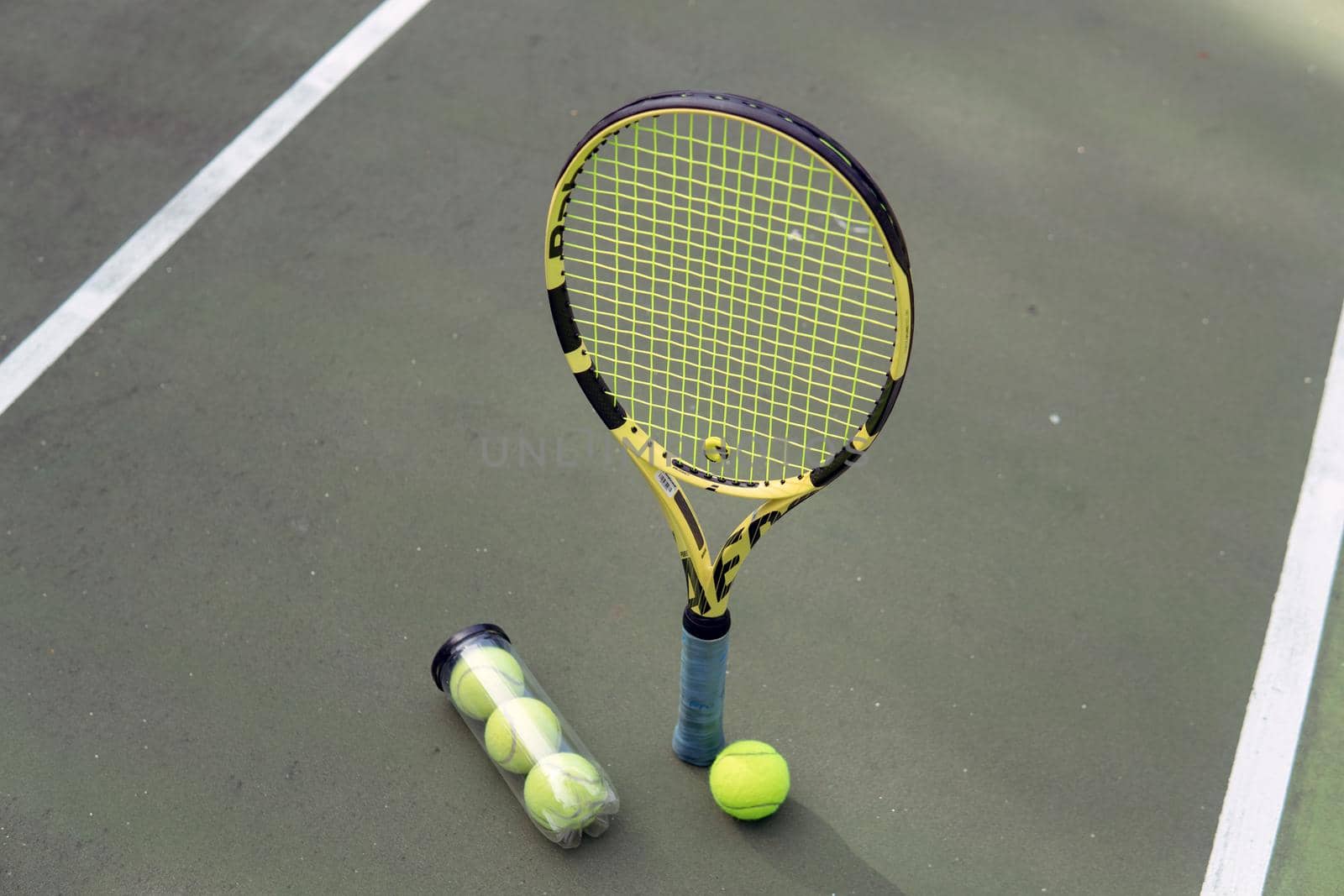 close-up. male hands holding tennis racket and balls by Alexzhilkin