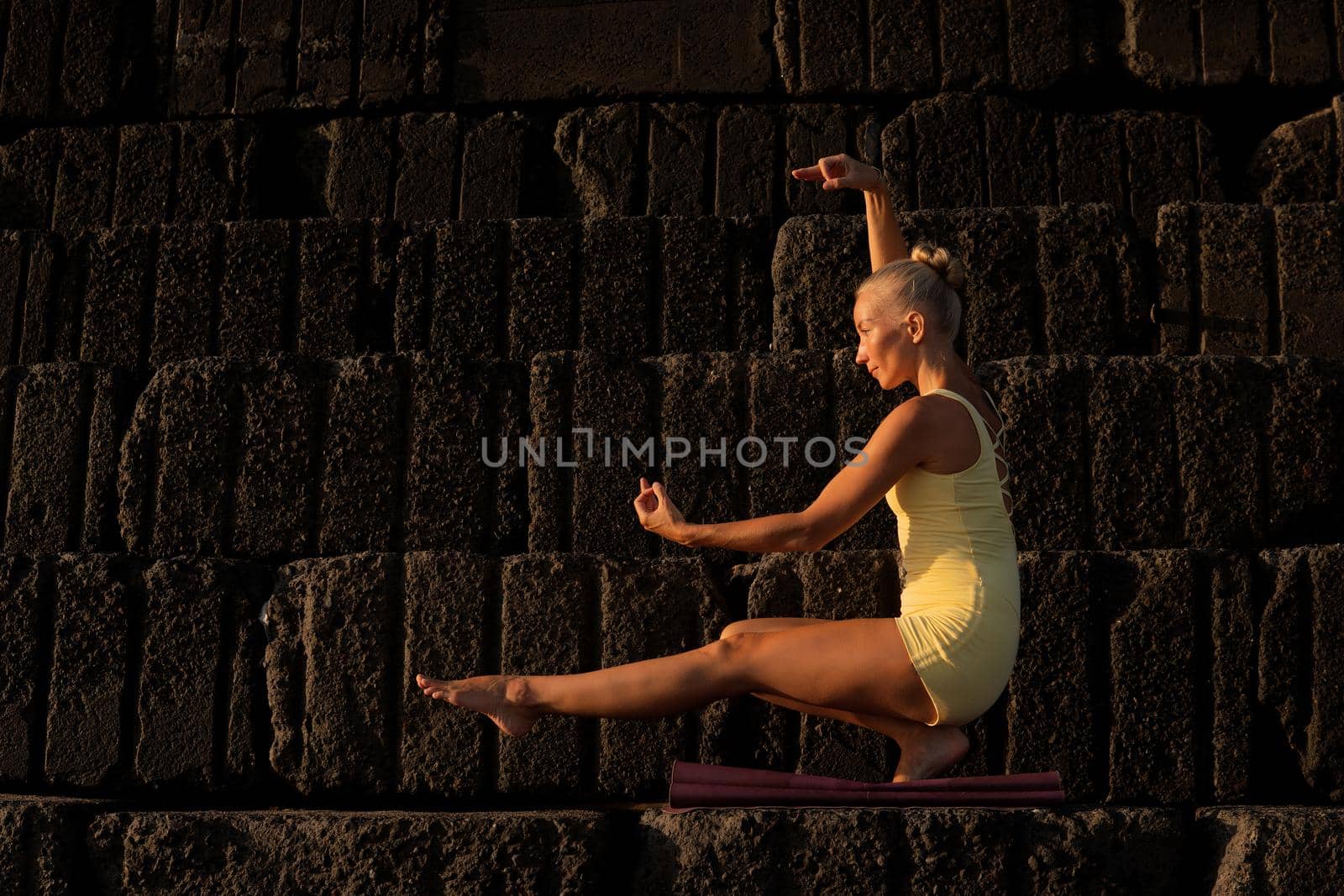 beautiful woman in yellow doing yoga. bali