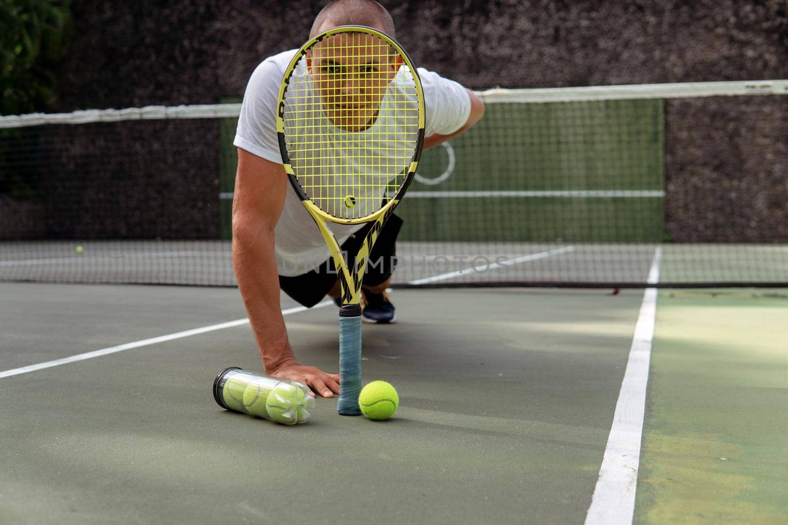 close-up. male hands holding tennis racket and balls. bali