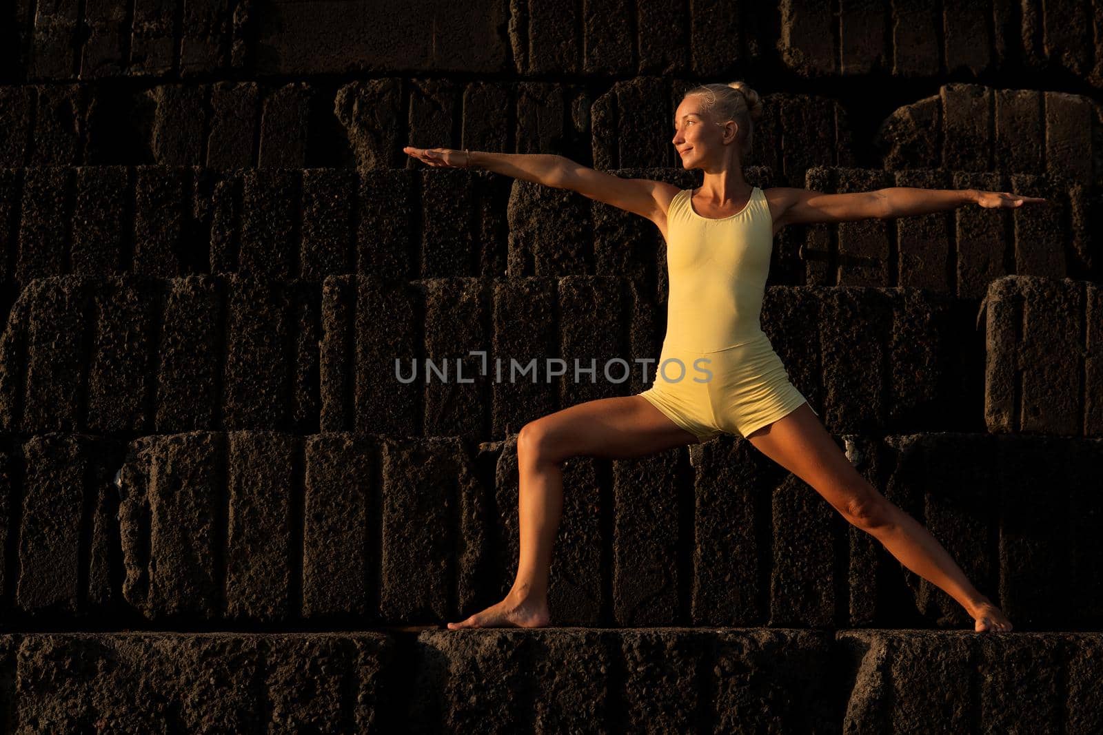 beautiful woman in yellow doing yoga. bali