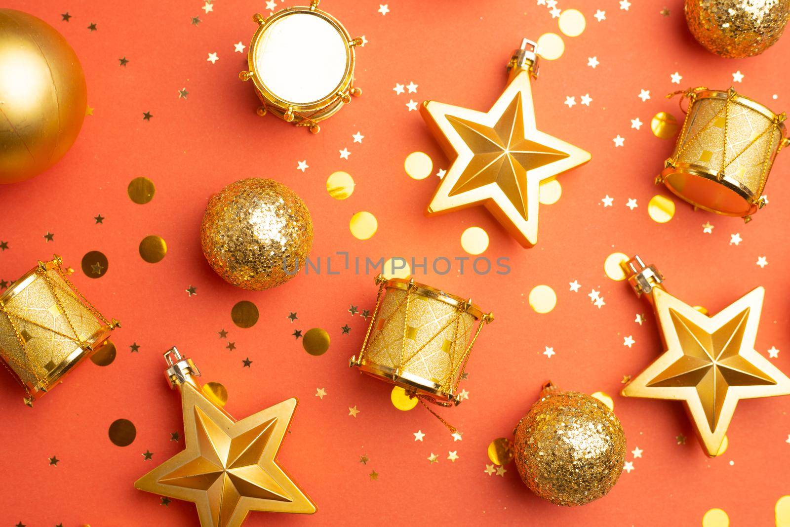 Layout of yellow Christmas toys on a red background . Christmas toys on a red background . Holiday. Festive decoration. Christmas Tree toys