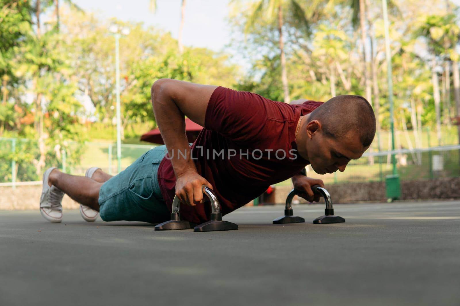 man doing push-ups on the court by Alexzhilkin