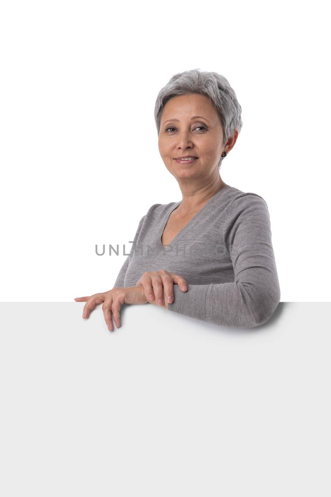 Mature business woman showing blank sign board. Asian busineeswoman in suit presenting billboard isolated on white background