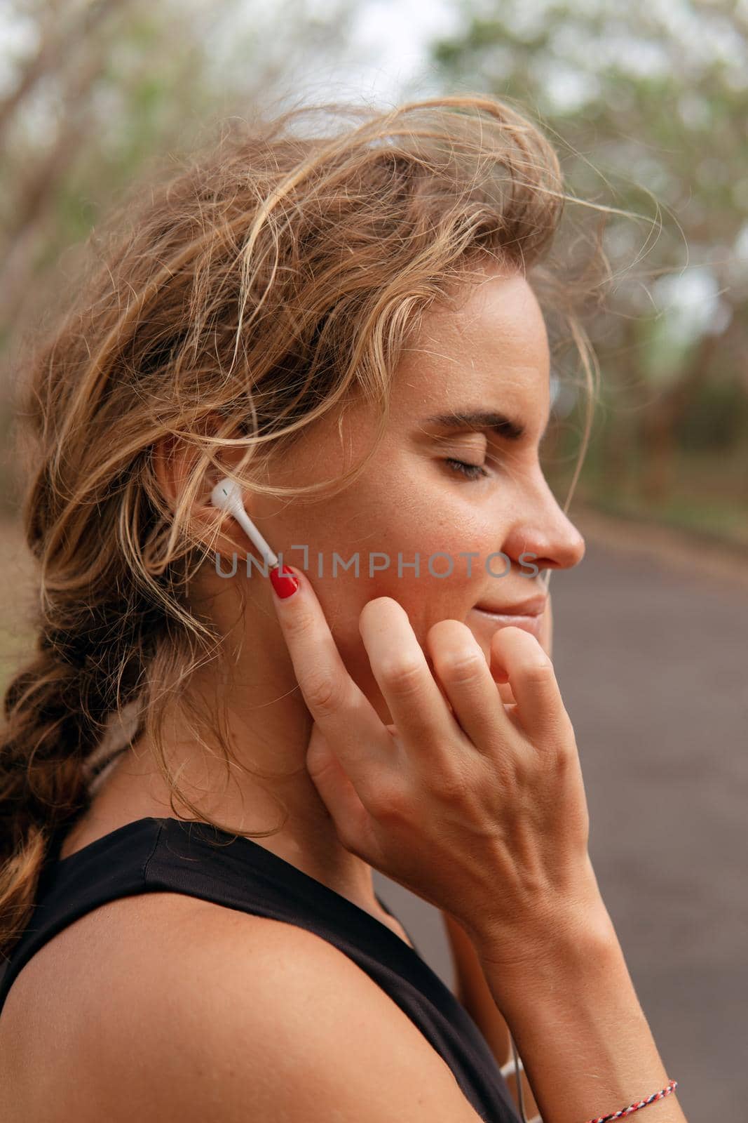 Beautiful woman listening to music. Close up by Alexzhilkin