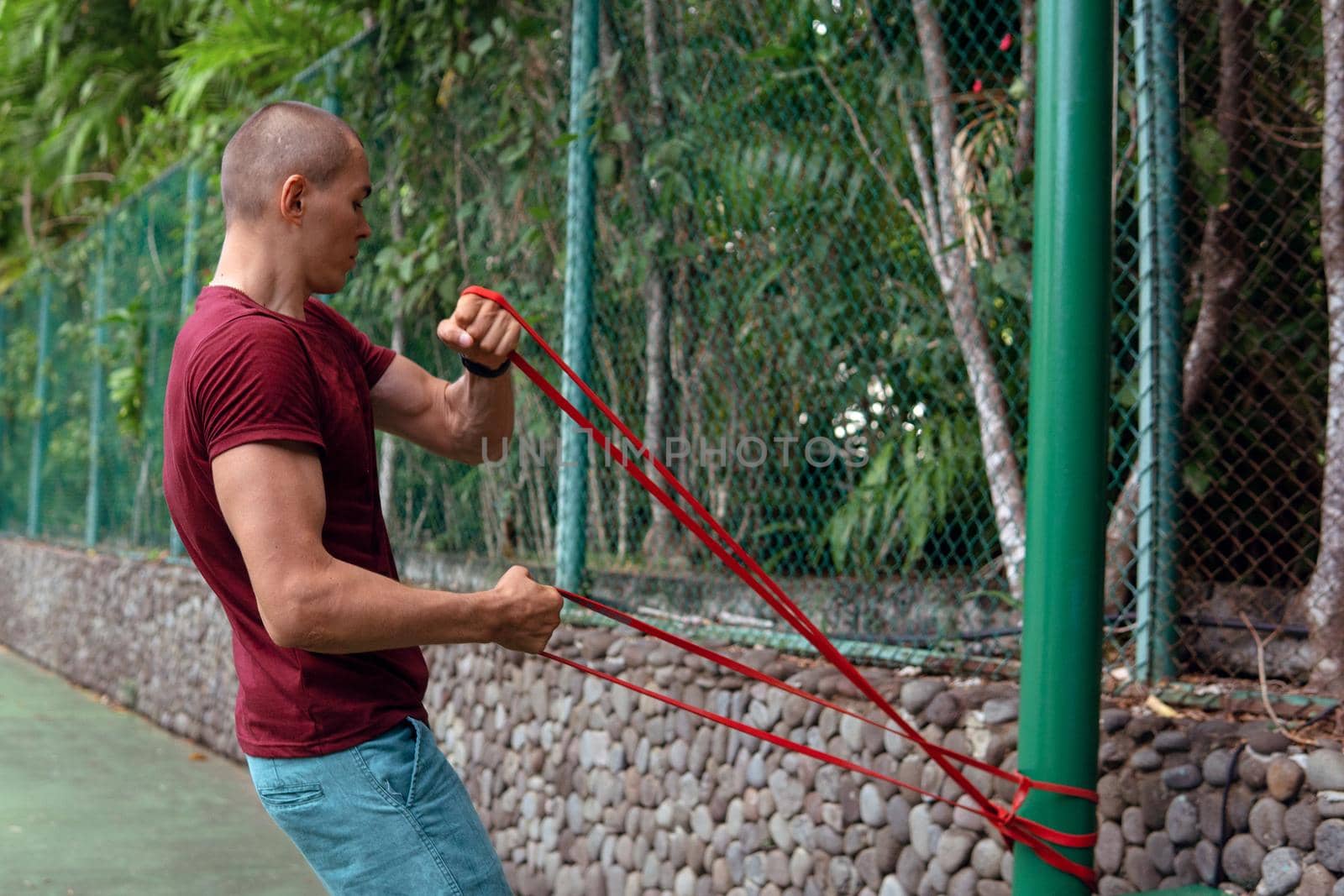 a man doing with rubber bands by Alexzhilkin