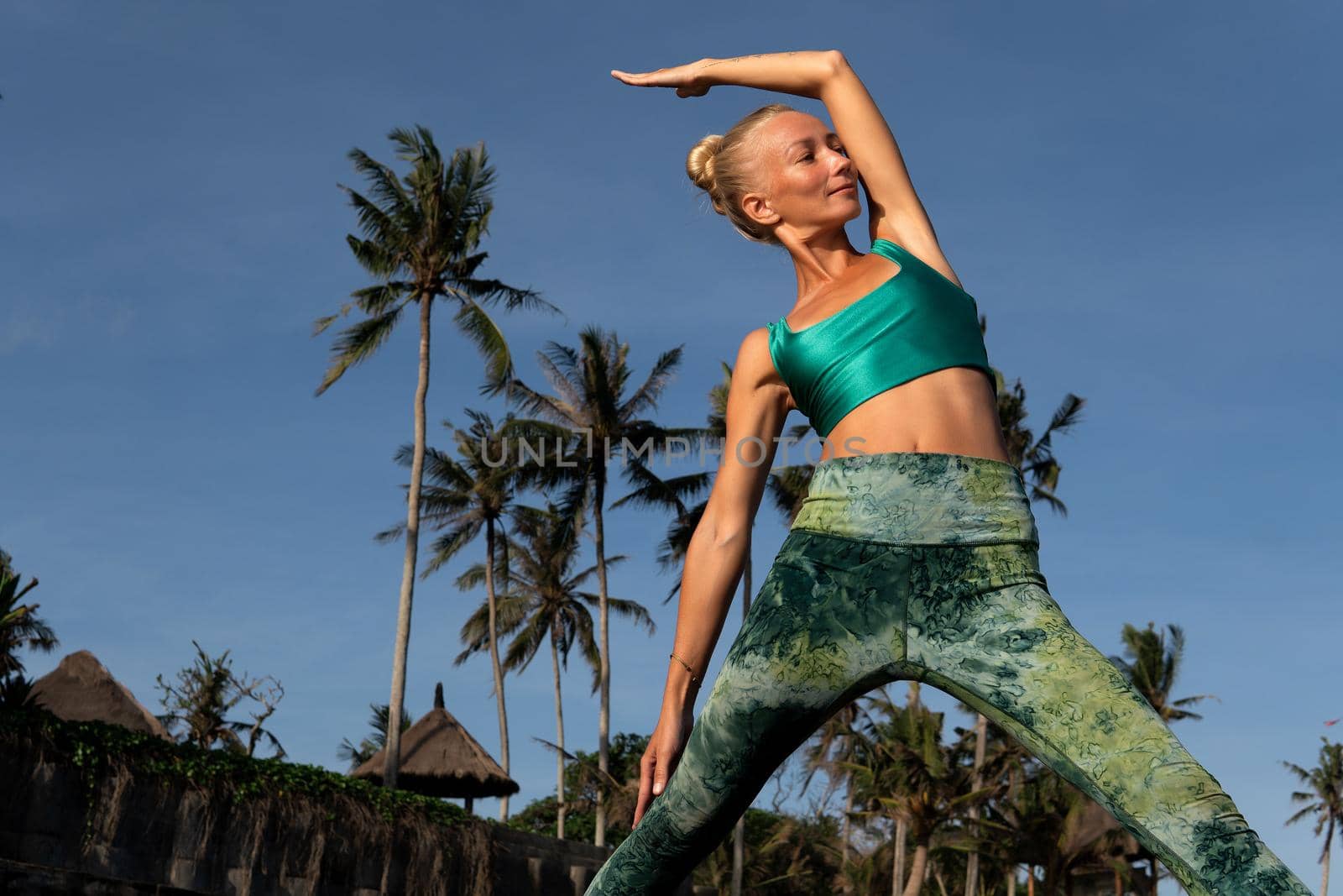 beautiful woman doing yoga. middle plan. bali