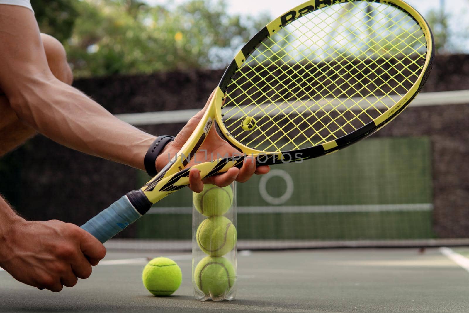 close-up. male hands holding tennis racket and balls. bali