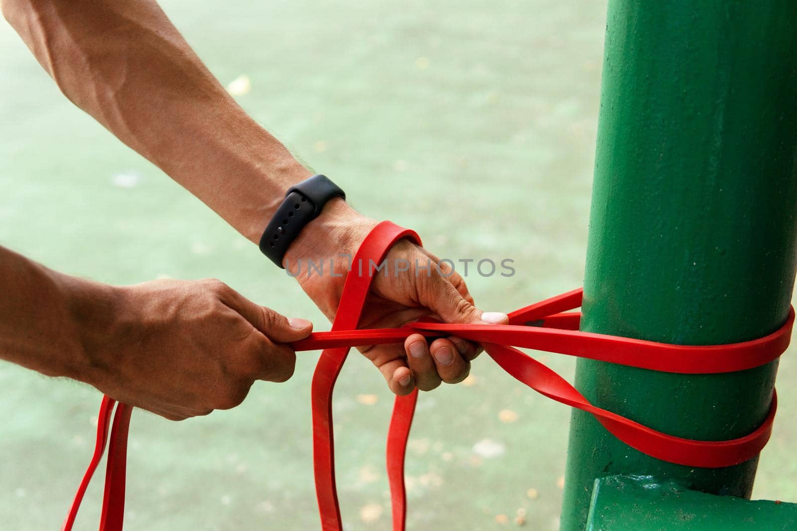 a man doing with rubber bands by Alexzhilkin