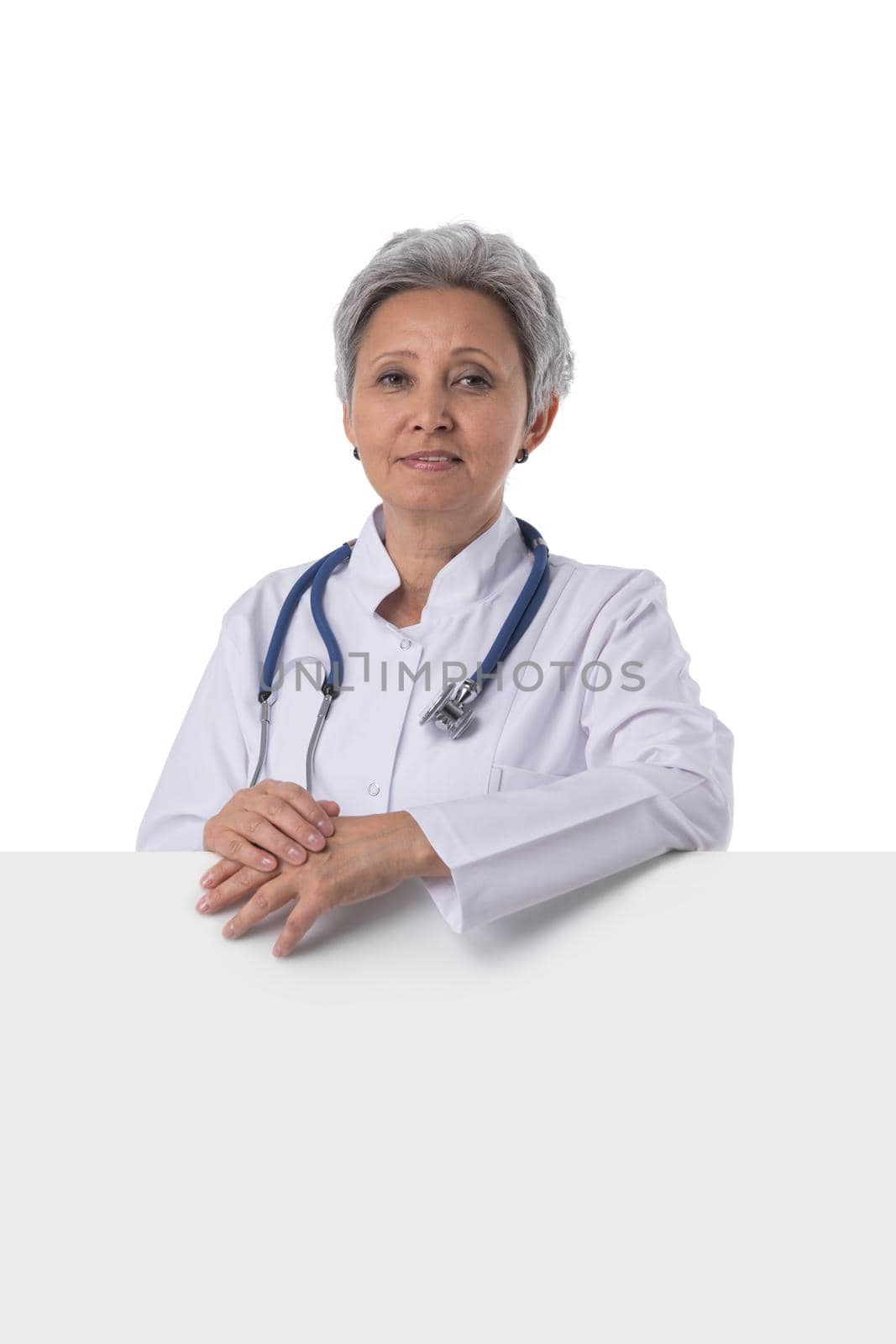 Mature asian doctor woman showing blank billboard, isolated on white background