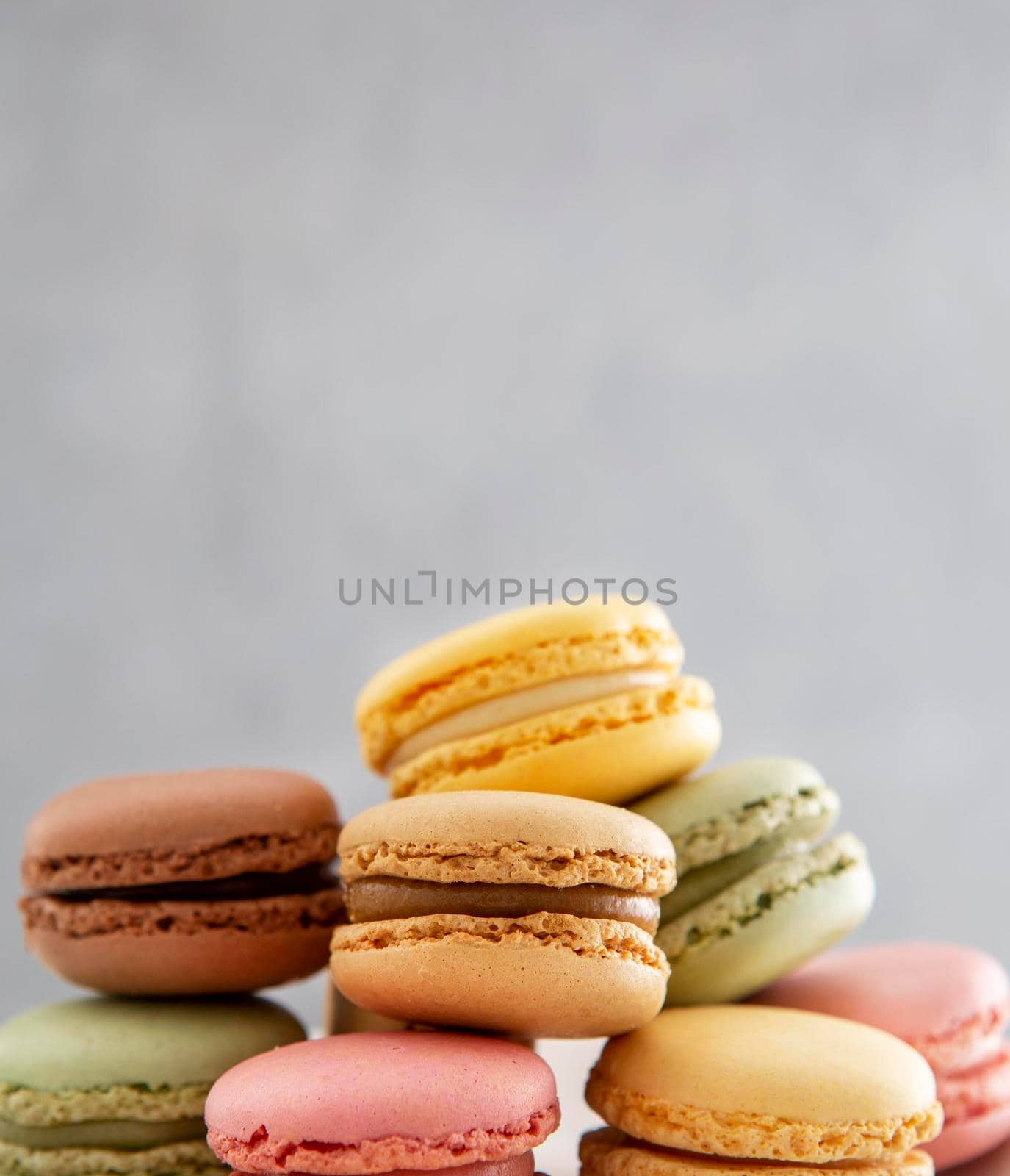 front view pile sweet macarons. High quality photo by Zahard