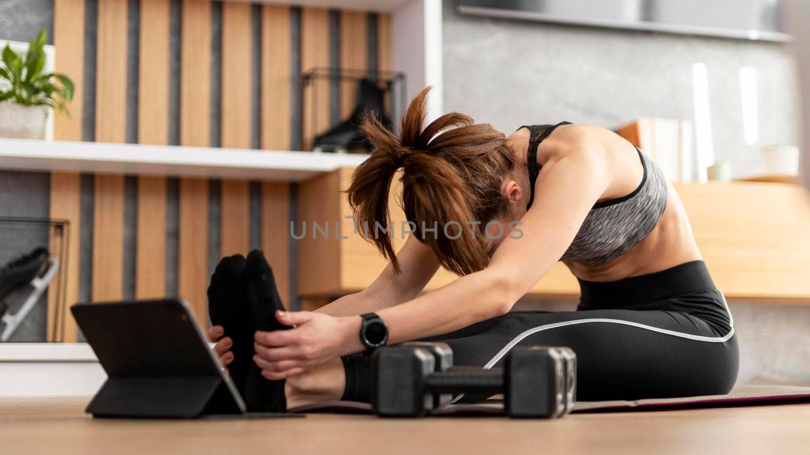 full shot woman stretching mat. High quality photo by Zahard