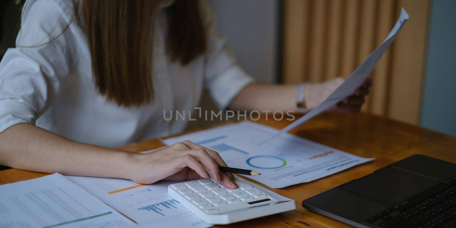 A businesswoman examines a financial chart in order to make arrangements. Investment concept for a business fund