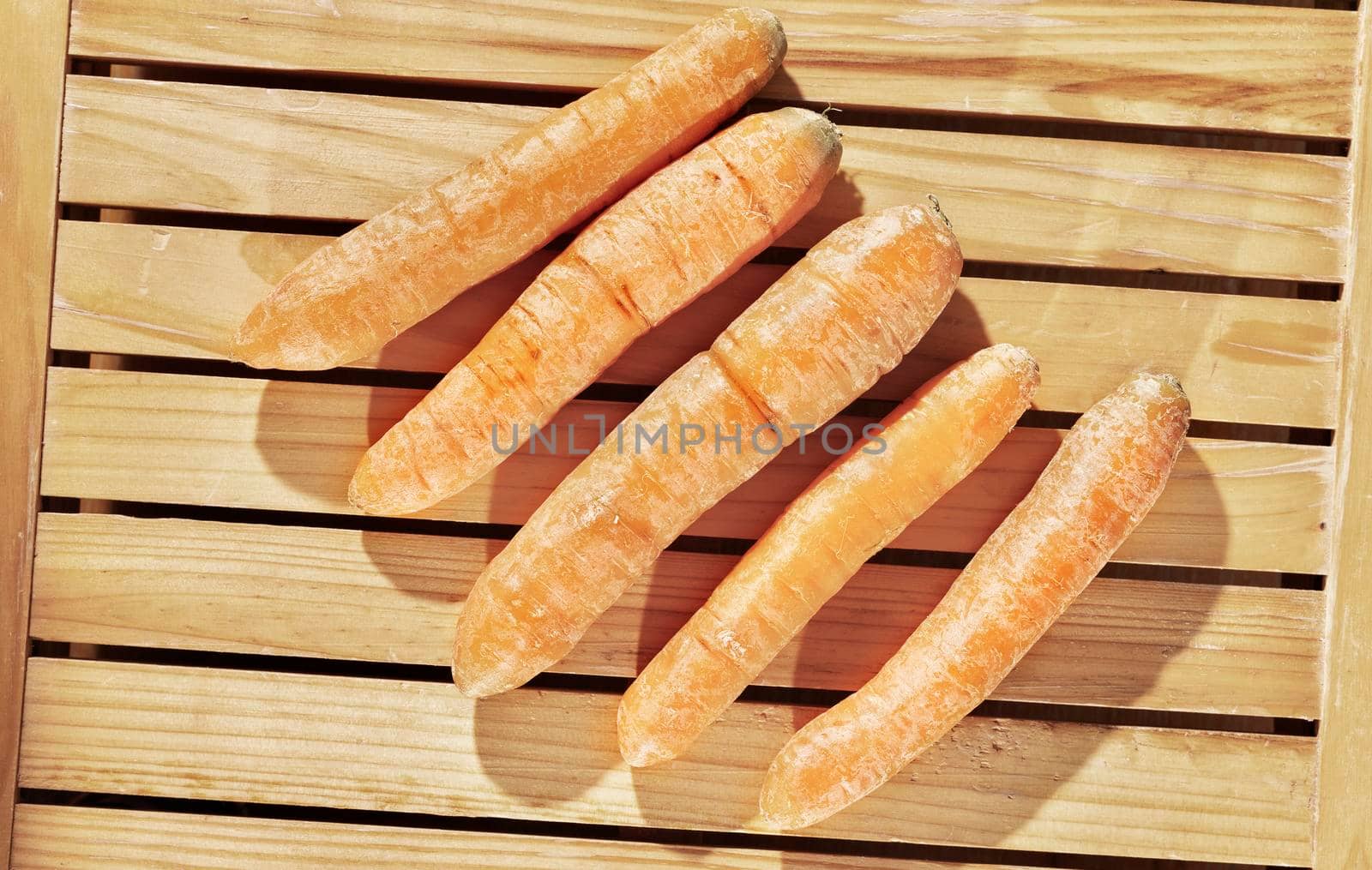Carrots on wooden table by victimewalker
