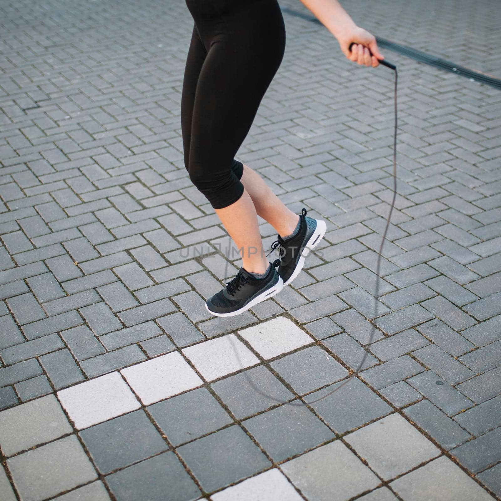 crop woman jumping with rope street. High quality photo by Zahard