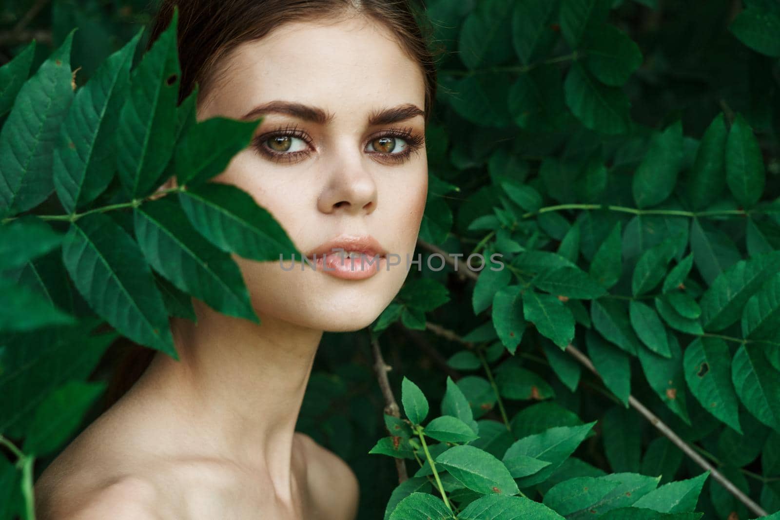 smiling woman green leaves clean skin nature summer model. High quality photo