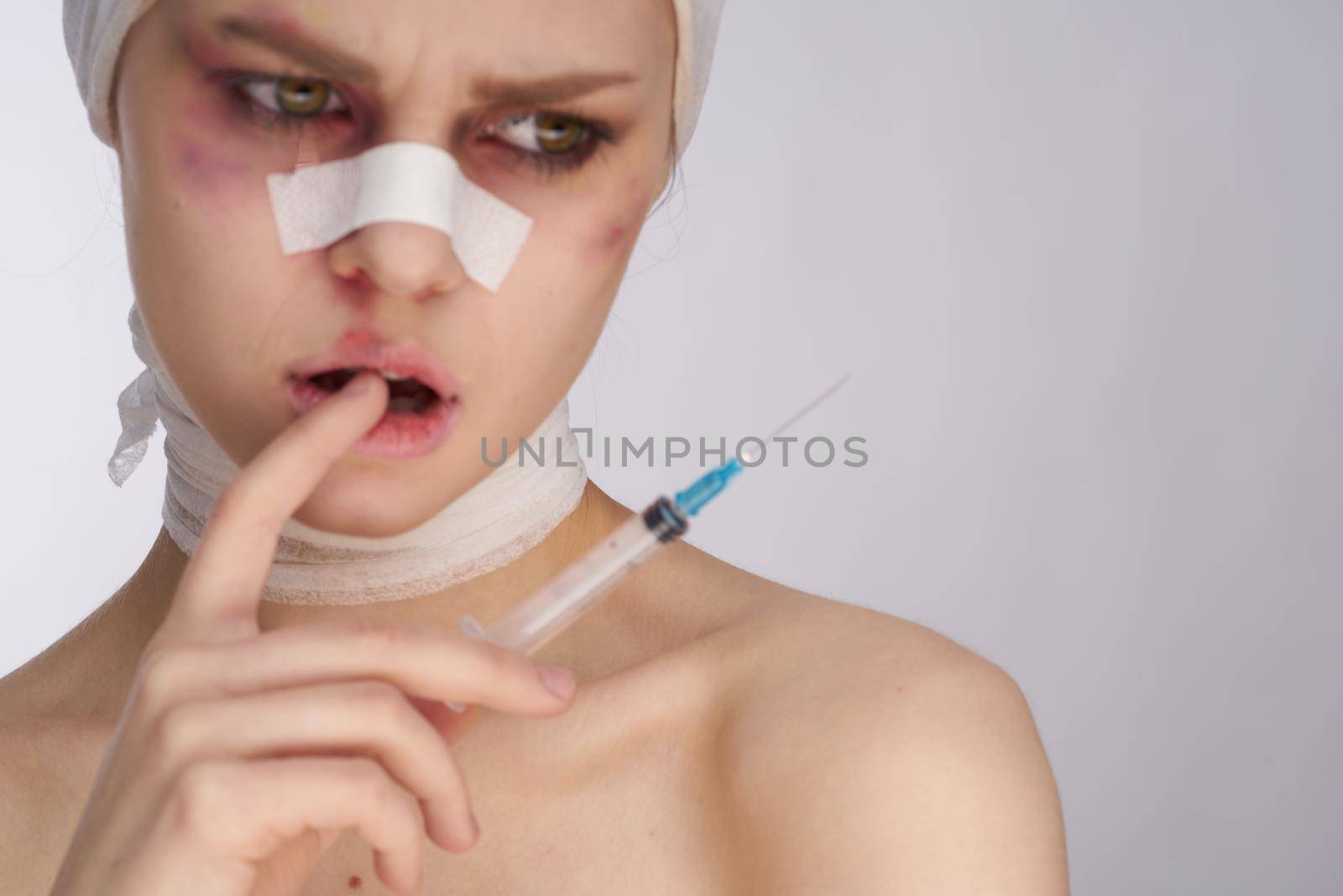 portrait of a woman woman after surgery syringe in hand injection isolated background. High quality photo
