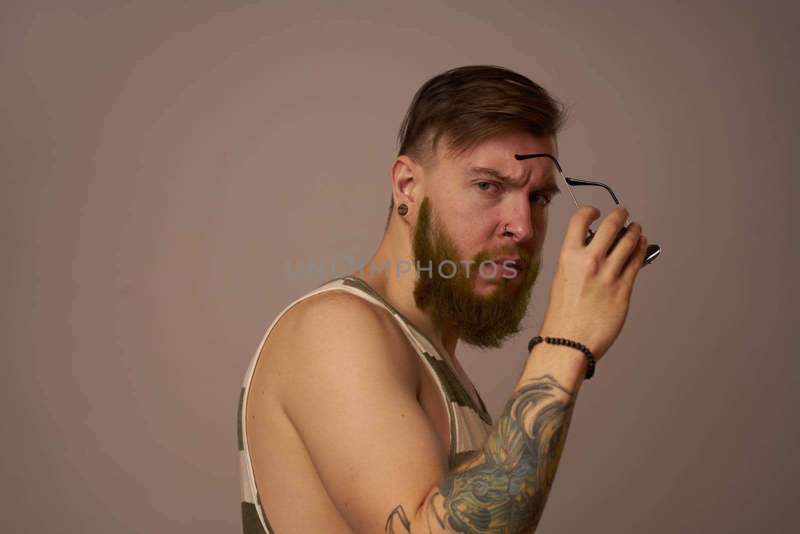 brutal man tattoos on his arms posing lifestyle form cropped view. High quality photo