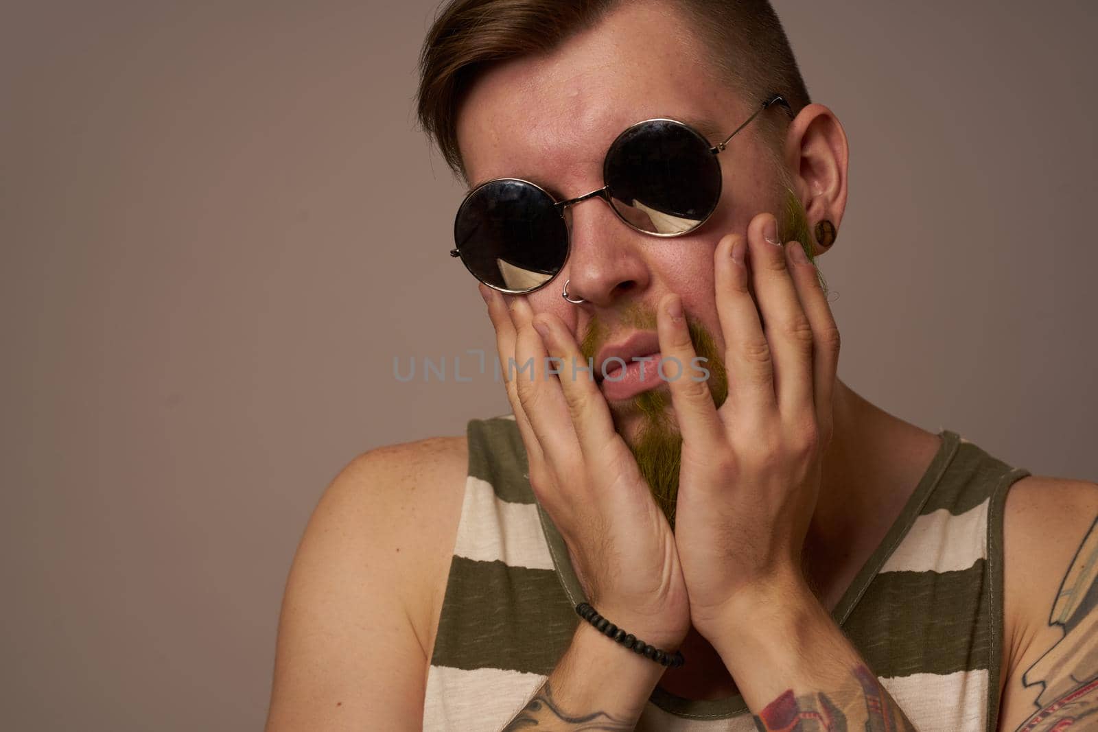 bearded man wearing sunglasses posing emotions isolated background. High quality photo