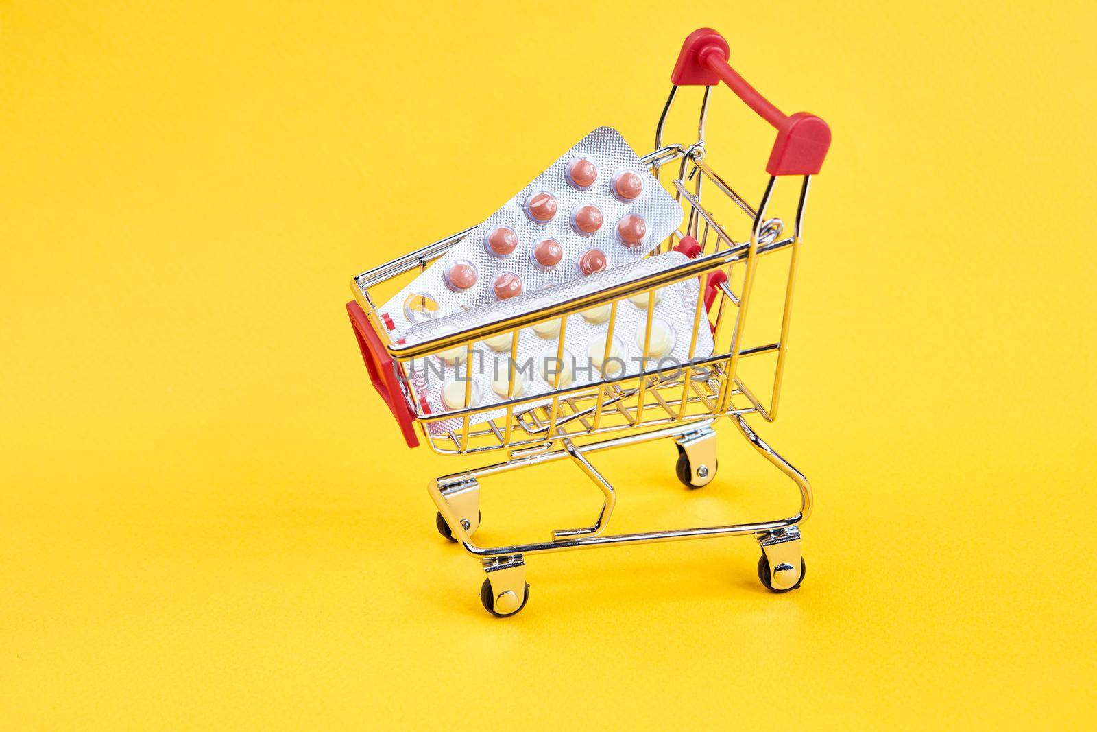 drug trolleys service delivery shopping pharmacy yellow background. High quality photo