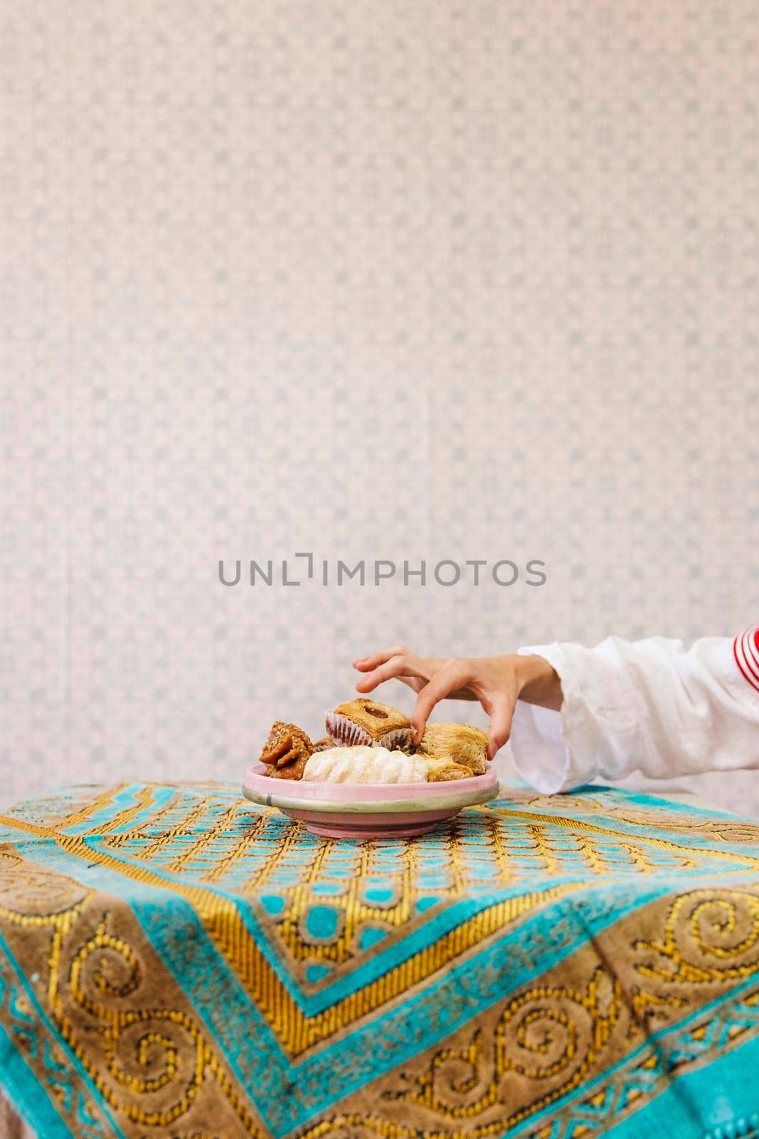 hand taking piece arab pastry. High quality photo by Zahard