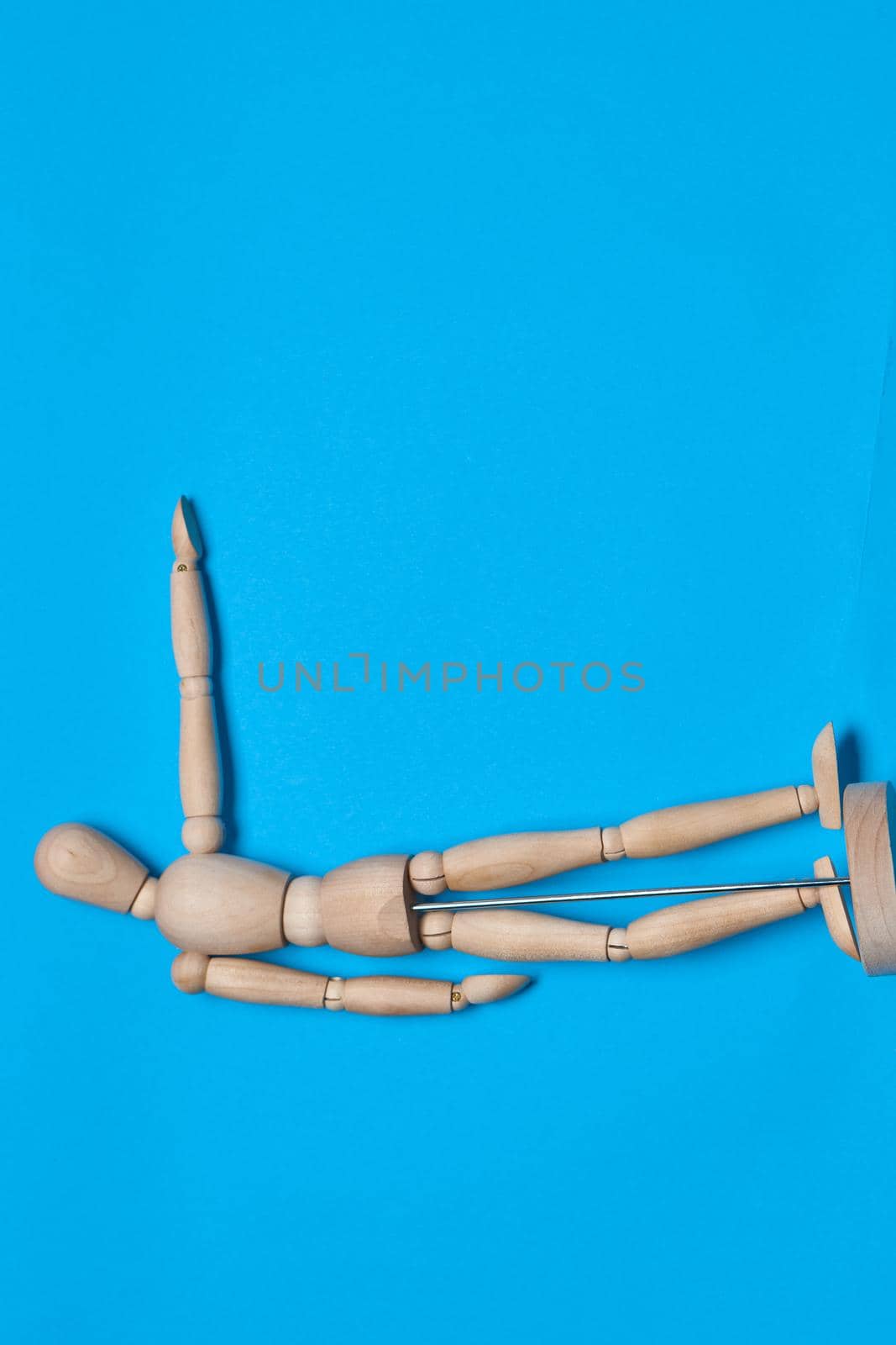 wooden man mannequin blue background design object. High quality photo