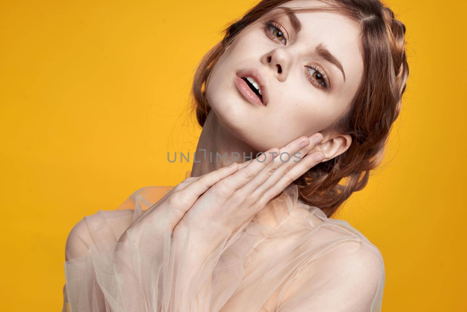 portrait of a woman gesture hands cosmetics fashion hairstyle posing yellow background by Vichizh