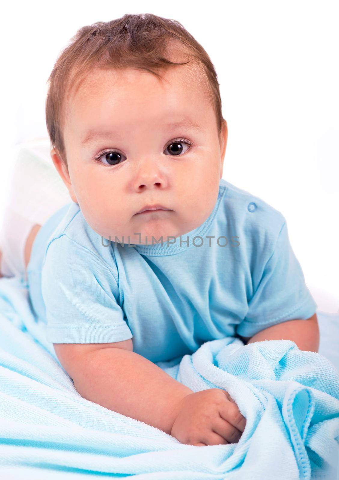 Little baby boy lying on the bed and smiling