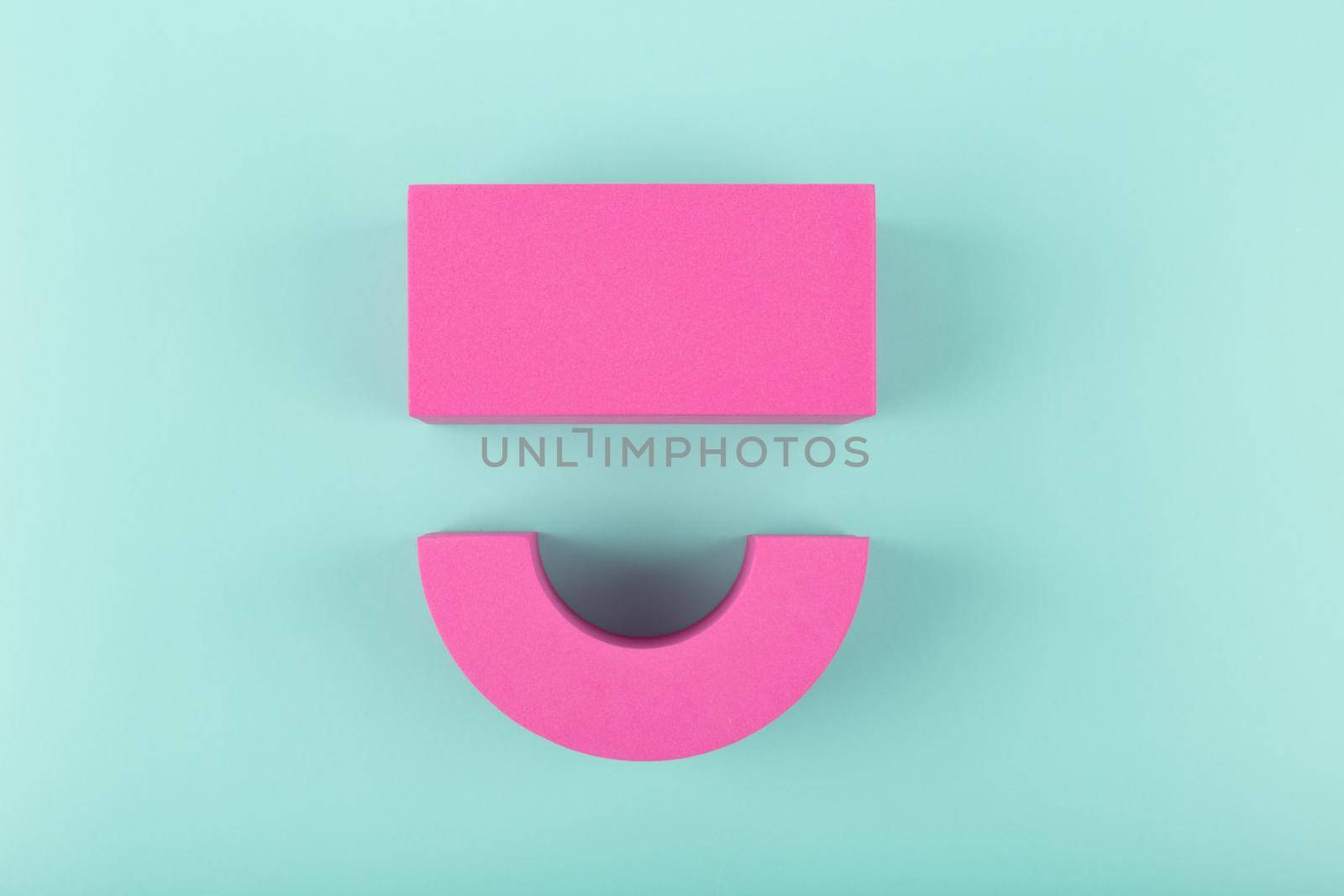 Creative flat lay with pink happy smile symbol made of figures on blue background with copy space. Concept of Smile day, emotions, emoji or mental health