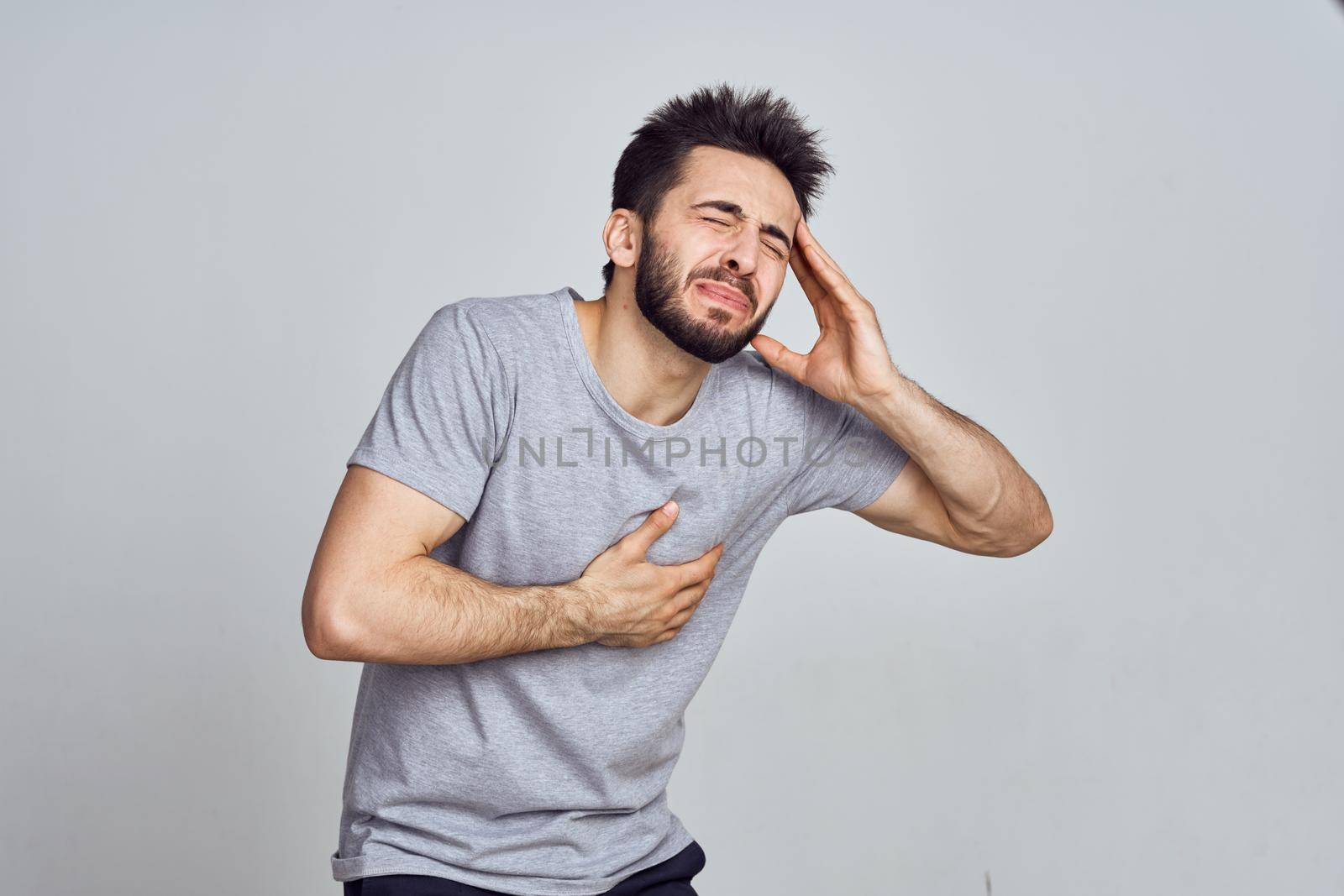 bearded man in white t-shirt posing gesturing with his hands. High quality photo