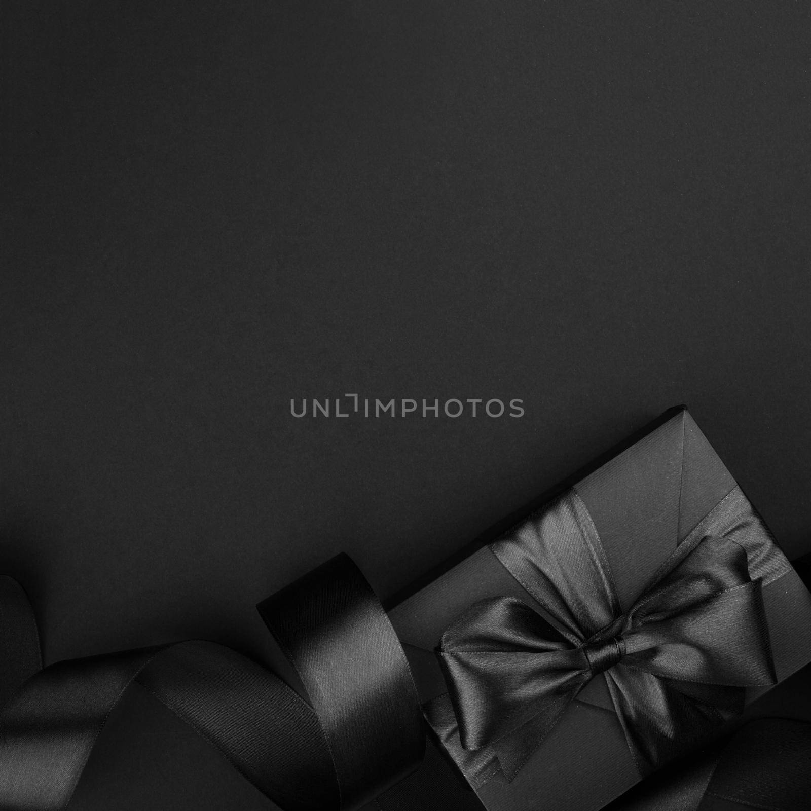 Black friday sale background with gift present box and curly ribbon with copy space for text ad