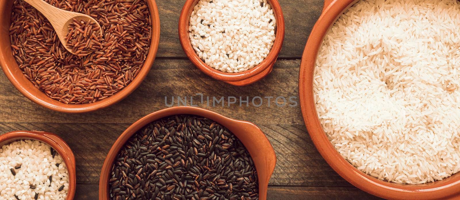 red brown white rice bowls wooden background. High resolution photo