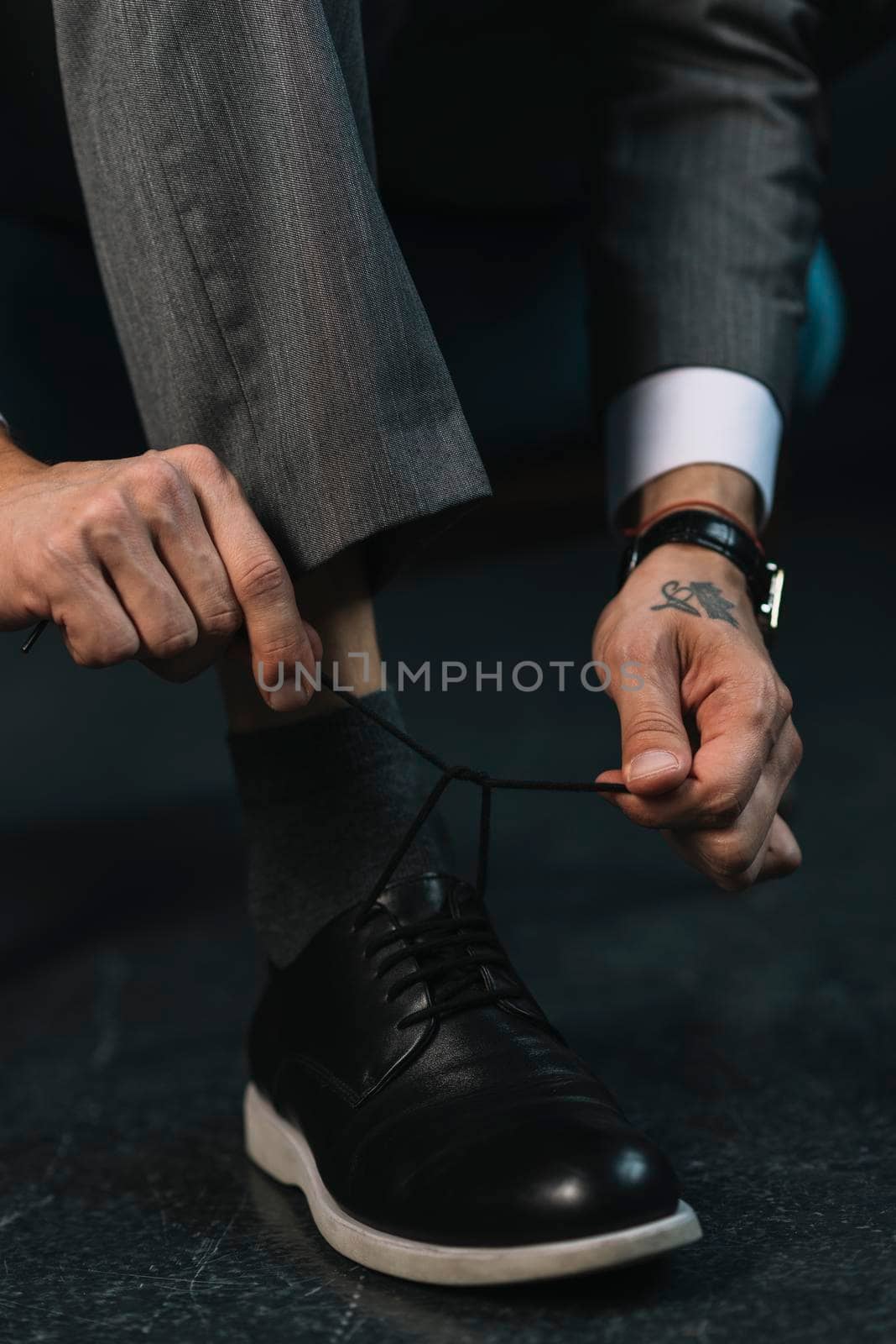 low section businessman s hand tying shoelace. High resolution photo