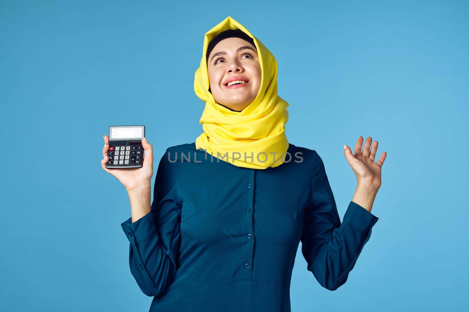 woman in yellow hijab technology calculator work finance by Vichizh