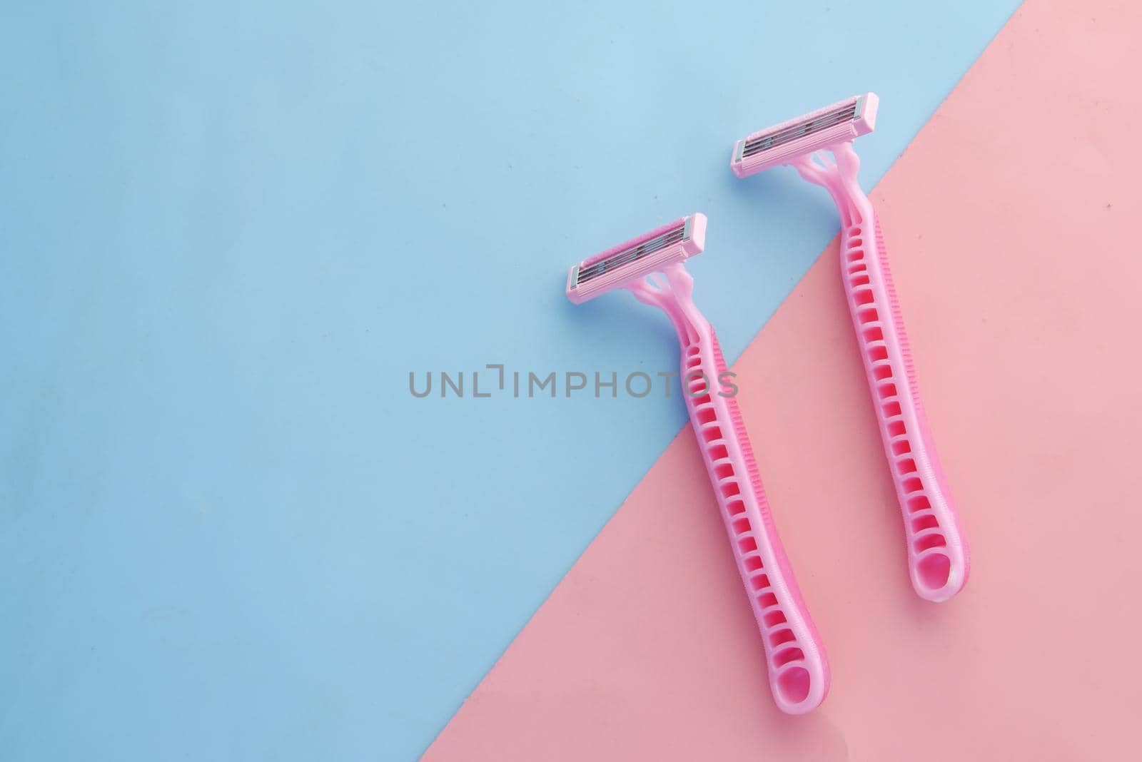 Pink Razor on pink background close up