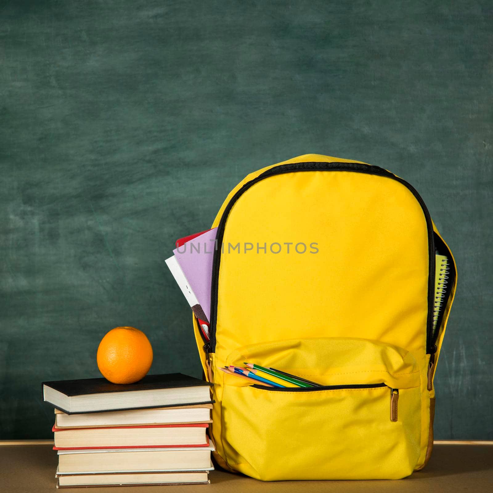 yellow backpack stack books orange. High quality photo by Zahard