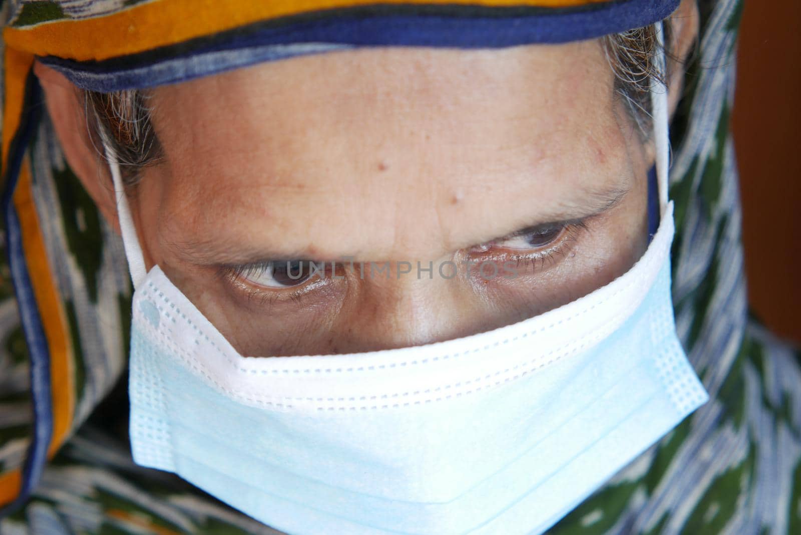 close up of senior asian women's eye with face mask.
